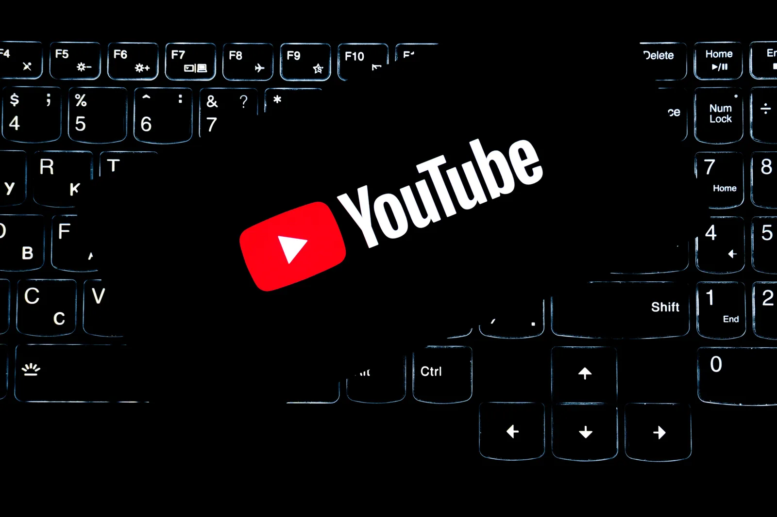YouTube logo displayed on a backlit keyboard, representing digital media and online content creation. Youtube channel startup: signal versus noise