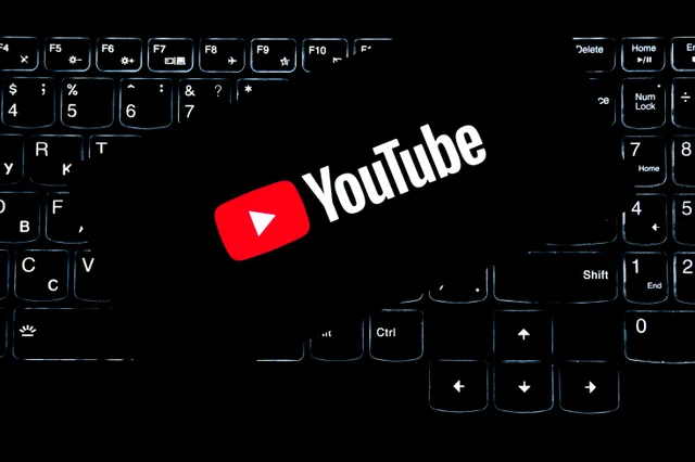 YouTube logo displayed on a backlit keyboard, representing digital media and online content creation. Youtube channel startup: signal versus noise