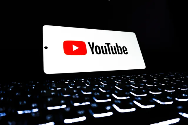 YouTube app icon displayed on a smartphone over an illuminated keyboard, representing digital media and online streaming. YouTube Estimated Tax Payments: Records to Keep